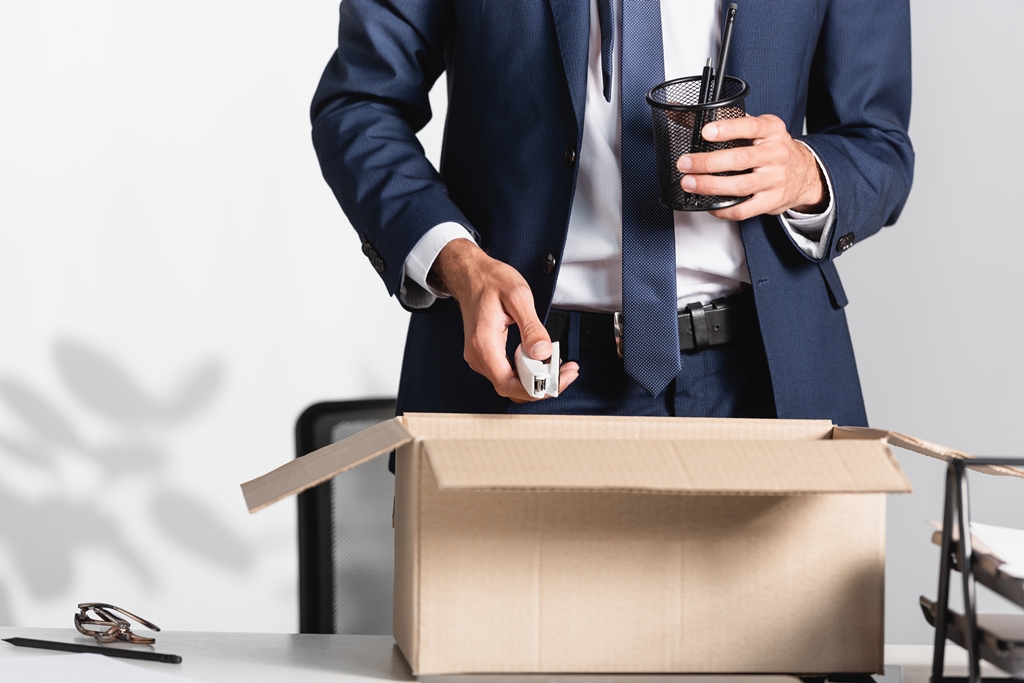 fired businessman holding a box